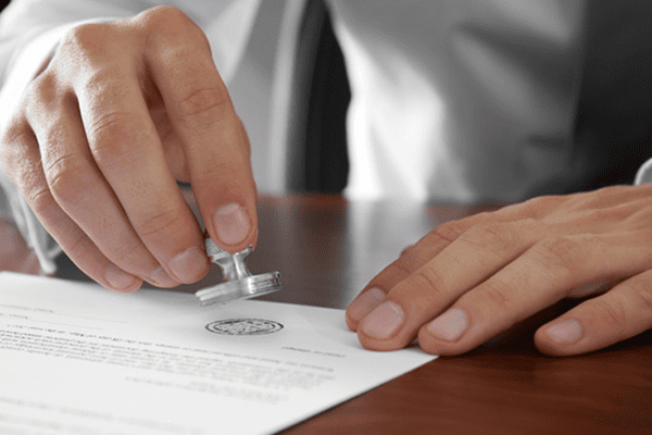 A lawyer stamping a seal on a document.