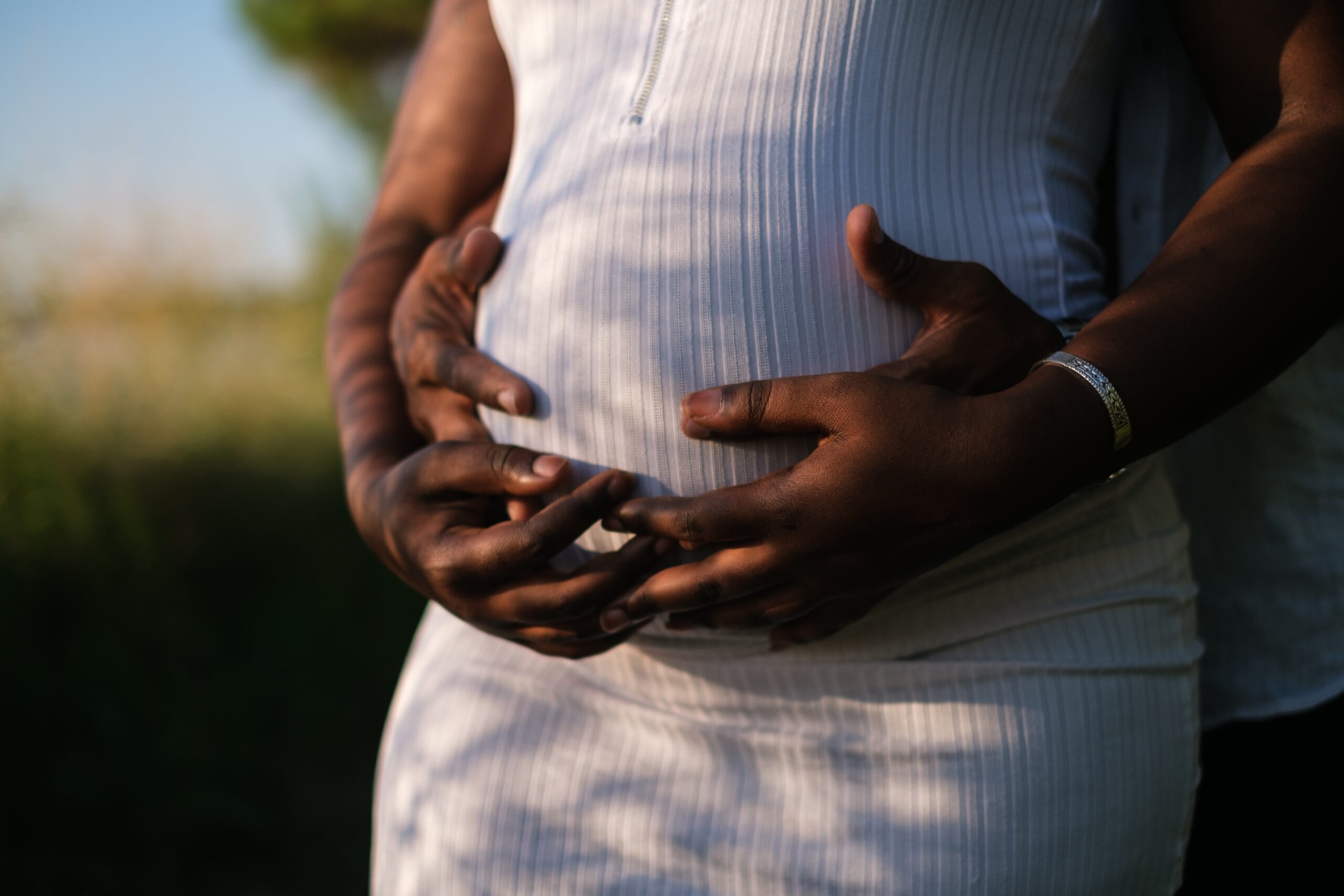 A man hugging a pregnant woman