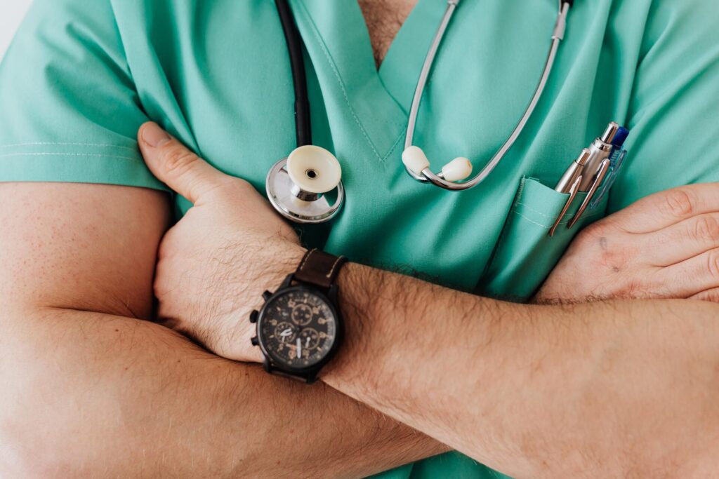 A person wearing green scrubs being sued for medical malpractice